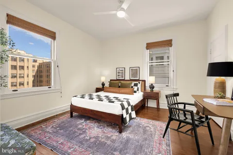 a bedroom with a bed a table and chair