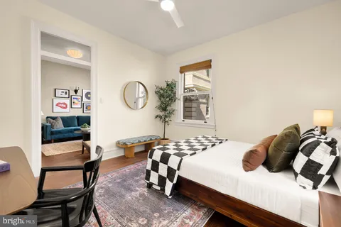 a living room with a couch and a potted plant