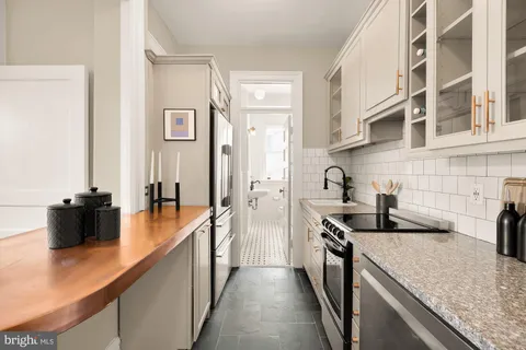 a kitchen with stainless steel appliances granite countertop a stove and a sink