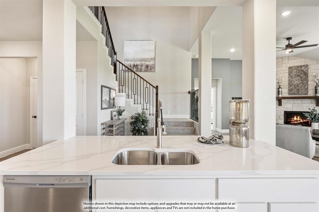 5418 Rutherford Drive Midlothian, TX 76065 - Photo 11 of 40 a kitchen with a sink a counter top space and living room view