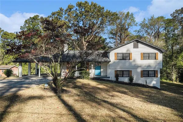 a front view of a house with a yard