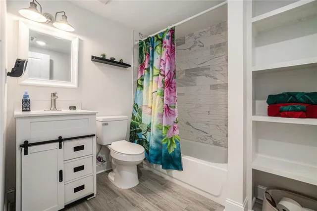 a bathroom with a sink toilet and shower