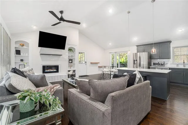 a living room with fireplace furniture and a flat screen tv