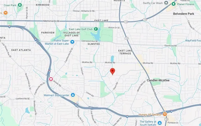 a white and black white umbrella sitting next to a white wall