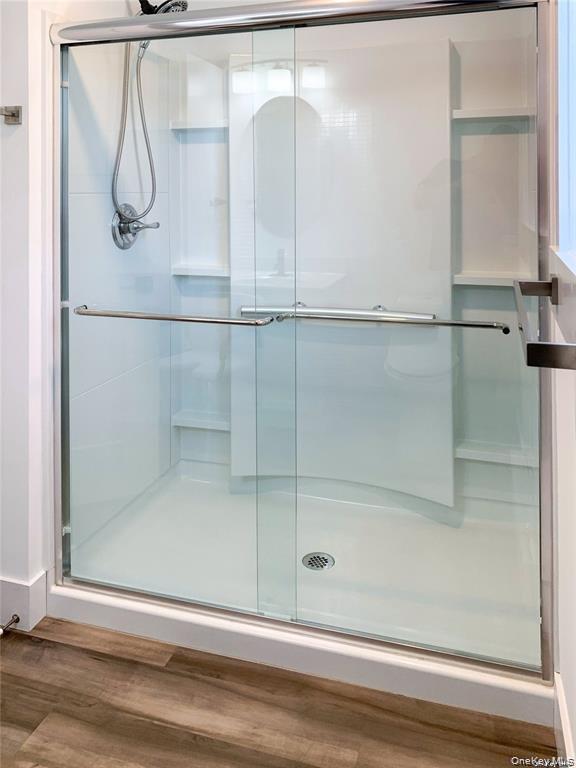 124 Prince Road Rocky Point, NY 11778 - Photo 5 of 10 a bathroom with a glass shower door