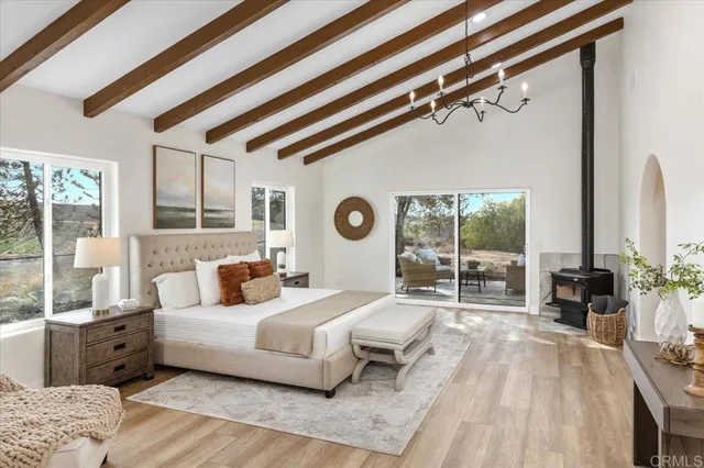 a bedroom with furniture and a mirror