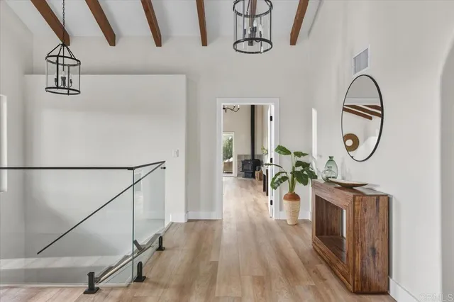 a view of a hallway with wooden floor and entryway