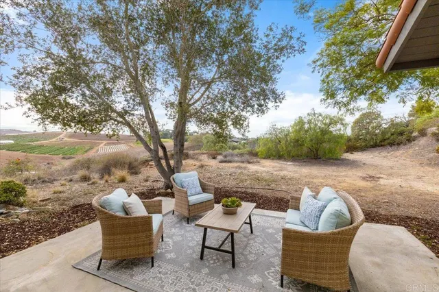a view of a room with a large window and wooden floor
