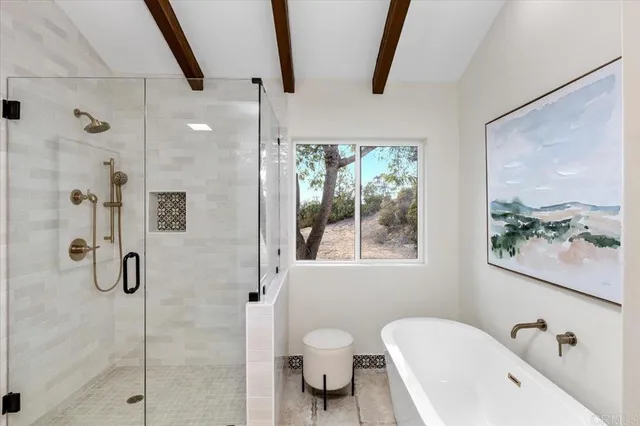 a patio with table and chairs and potted plants with wooden floor and plants