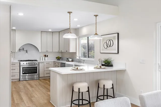 a kitchen with a sink cabinets and window