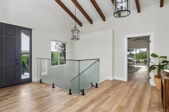 a view of a livingroom with furniture wooden floor a chandelier