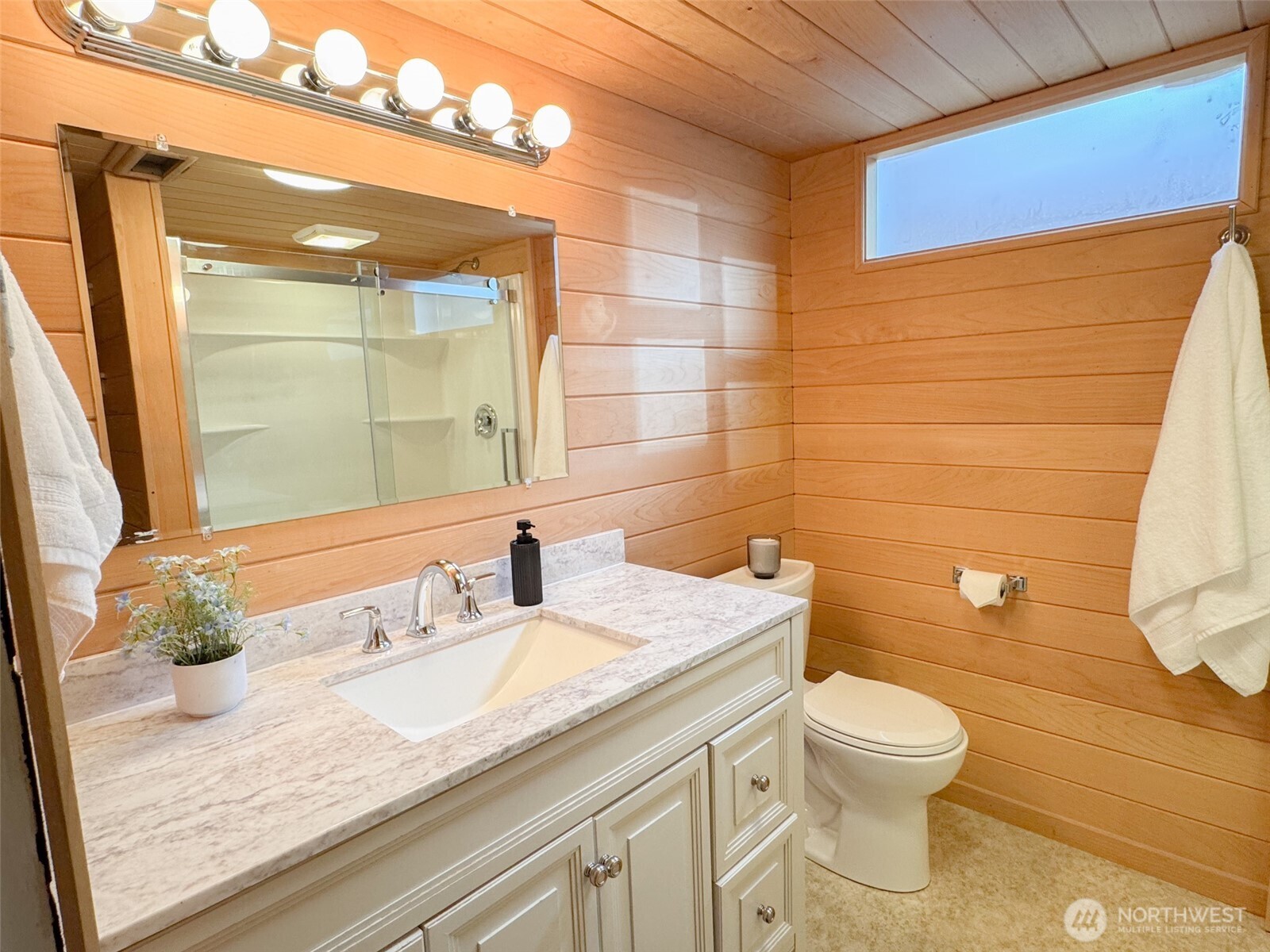 126 West 6th Street Port Angeles, WA 98362 - Photo 22 of 40 a bathroom with a granite countertop sink a toilet and a mirror