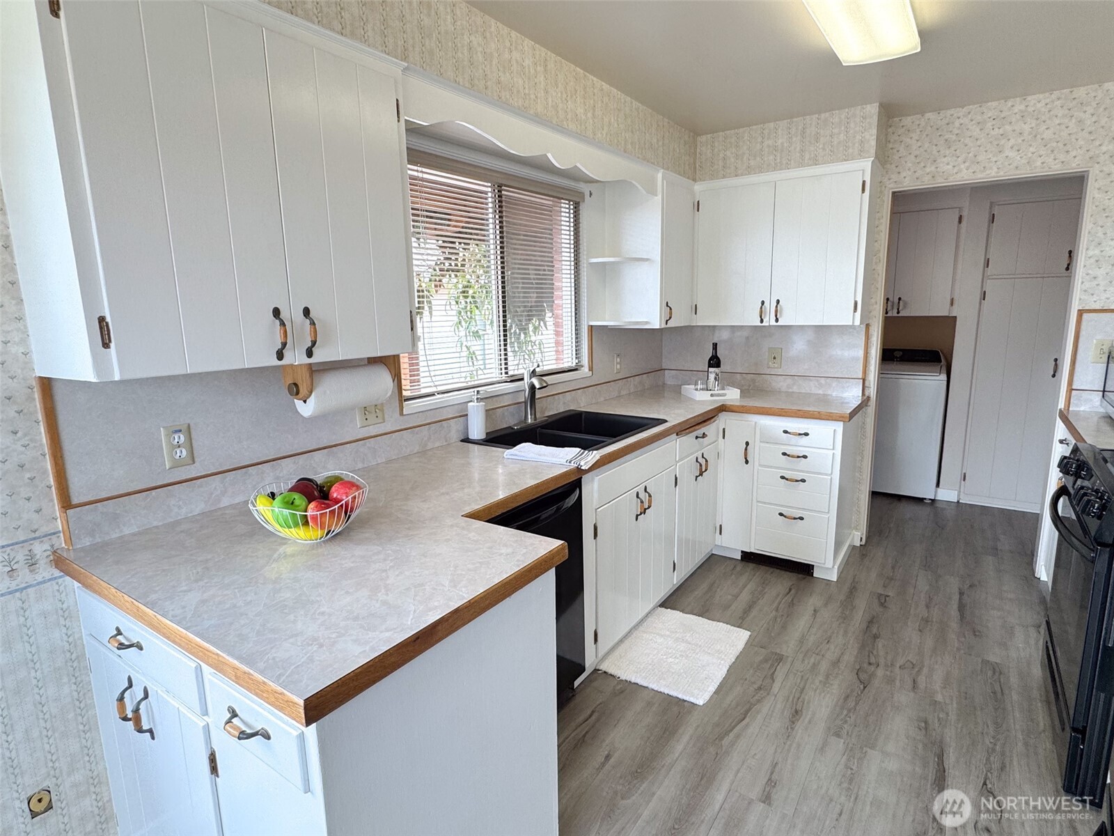 126 West 6th Street Port Angeles, WA 98362 - Photo 8 of 40 a kitchen with a sink a stove and cabinets