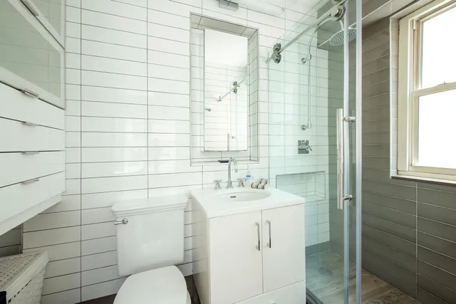 a spacious bedroom with a large bed and a chandelier