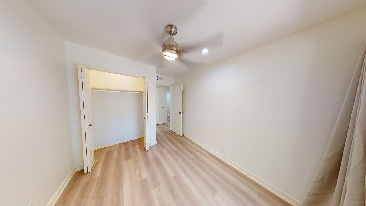 500 East Riverside Drive, Unit 132 Austin, TX 78704 - Photo 15 of 18 a view of a room with wooden floor and a ceiling fan