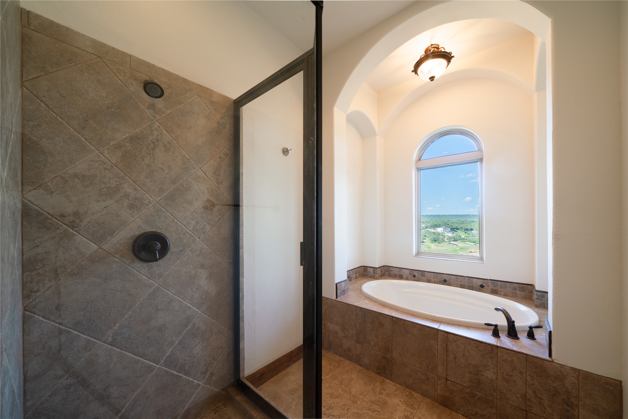 17545 West Reed Park Road, Unit 2 Jonestown, TX 78645 - Photo 21 of 39 a bathroom with a tub and a shower