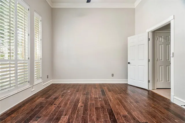a view of a livingroom with wooden floor and a ceiling fan