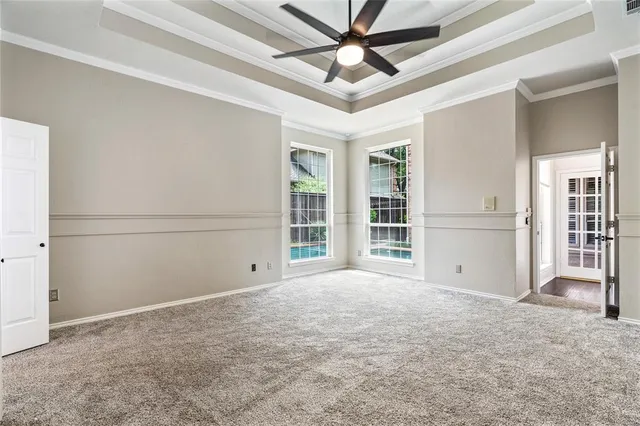 a view of livingroom with flat screen tv with a large window and wooden floor