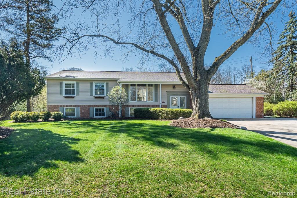 1841 Fair Oak Court Rochester, MI 48309 - Photo 1 of 36 Bi-level home featuring brick siding, a garage, a front lawn, and driveway