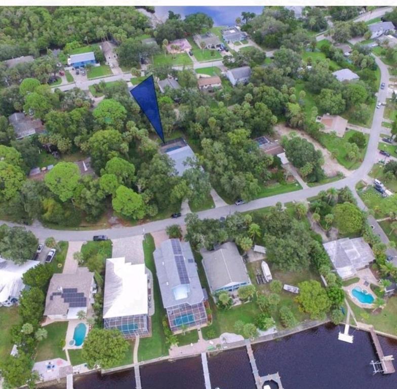 an aerial view of house with yard swimming pool and outdoor seating