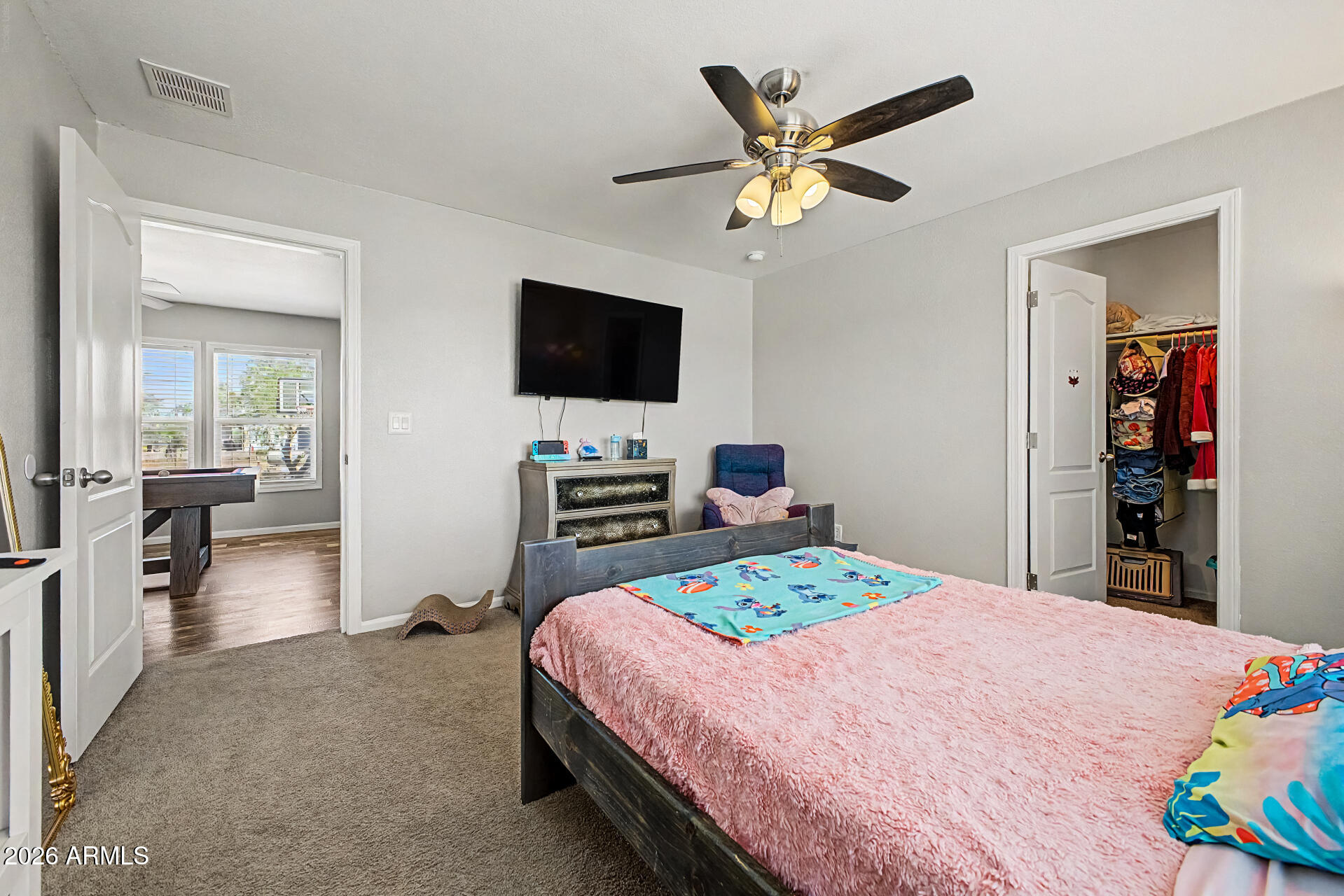 22417 West Dove Valley Road Wittmann, AZ 85361 - Photo 26 of 53 a bedroom with a bed and a flat screen tv