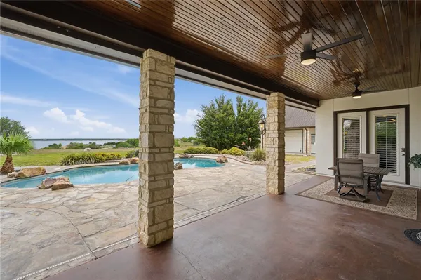 a view of a swimming pool and lounge chair