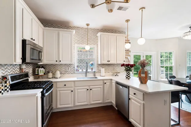 a kitchen with a sink a counter top space and a center island