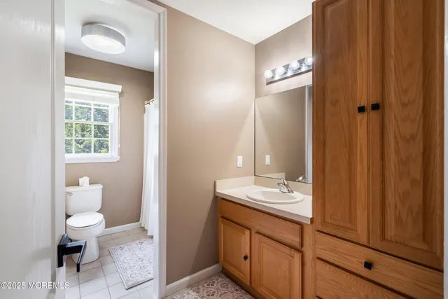 a large room with lots of furniture and a view of kitchen