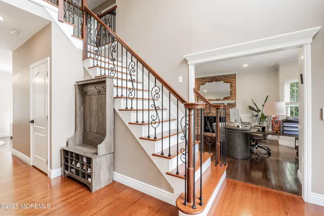 a view of entryway and hall with wooden floor
