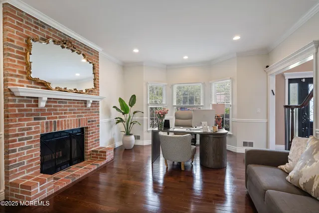 a living room with furniture a fireplace and a large window