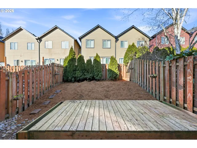 a view of a house with wooden fence