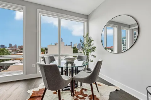 a dining room with furniture and wooden floor