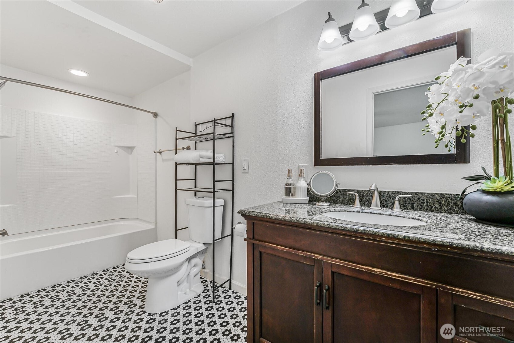11404 Karshner Road East Edgewood, WA 98372 - Photo 20 of 40 a bathroom with a granite countertop sink toilet mirror and shower