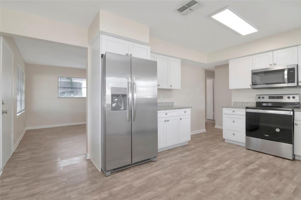 126 Kingsway Road Brandon, FL 33510 - Photo 21 of 42 a kitchen with stainless steel appliances a refrigerator and a stove