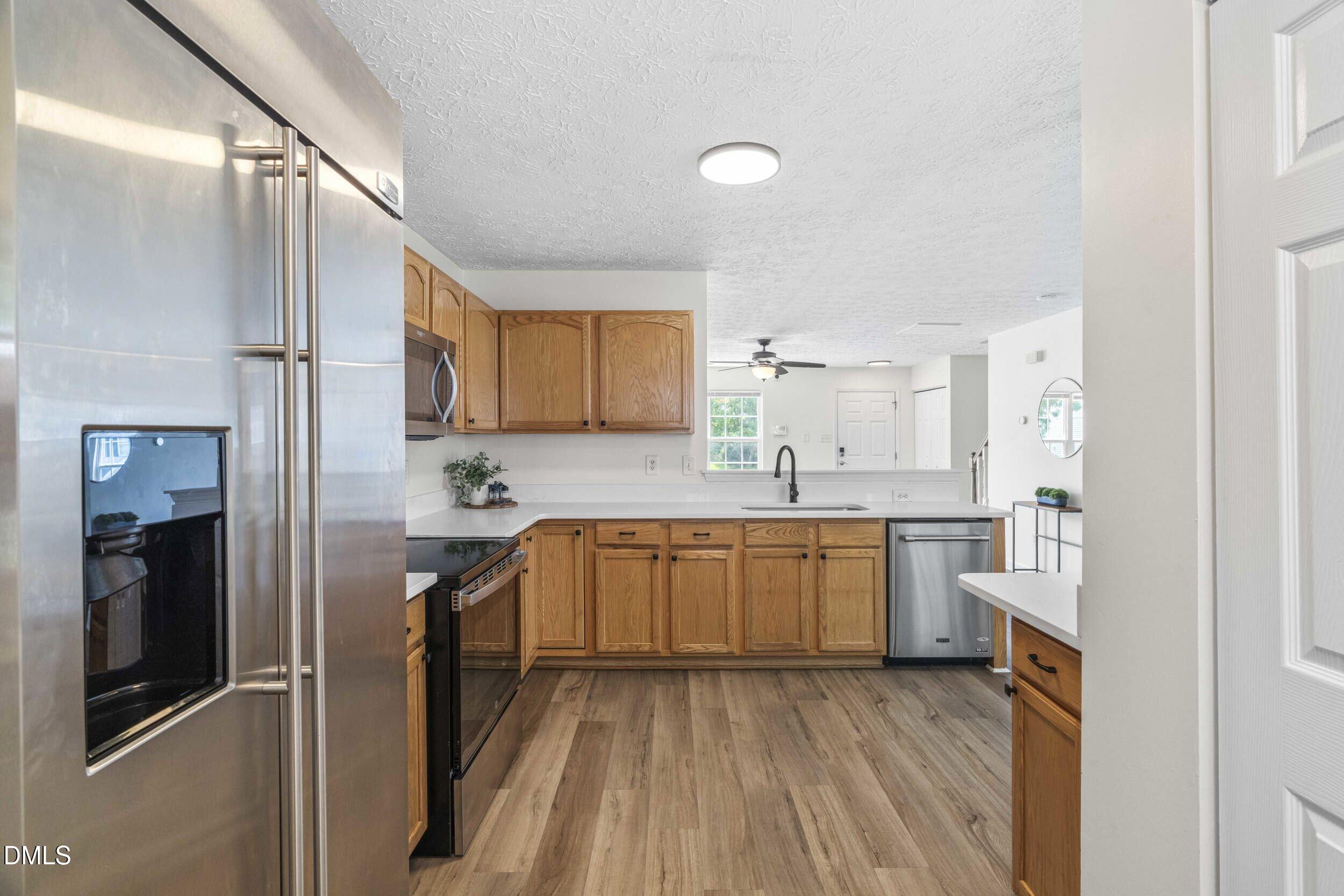 4121 Tensity Drive Raleigh, NC 27604 - Photo 12 of 34 Kitchen with stainless side-by-side refrigerator and ample cabinet space