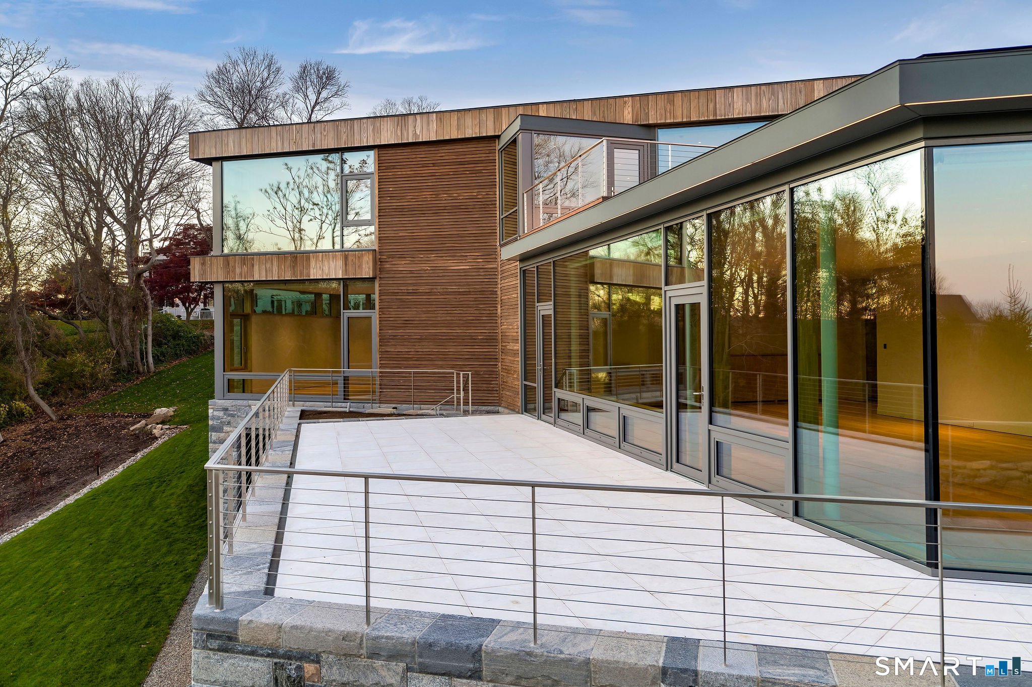 314 Ferry Road Old Lyme, CT 06371 - Photo 10 of 40 A gleaming white limestone deck wraps around the living room, dining room, and kitchen.