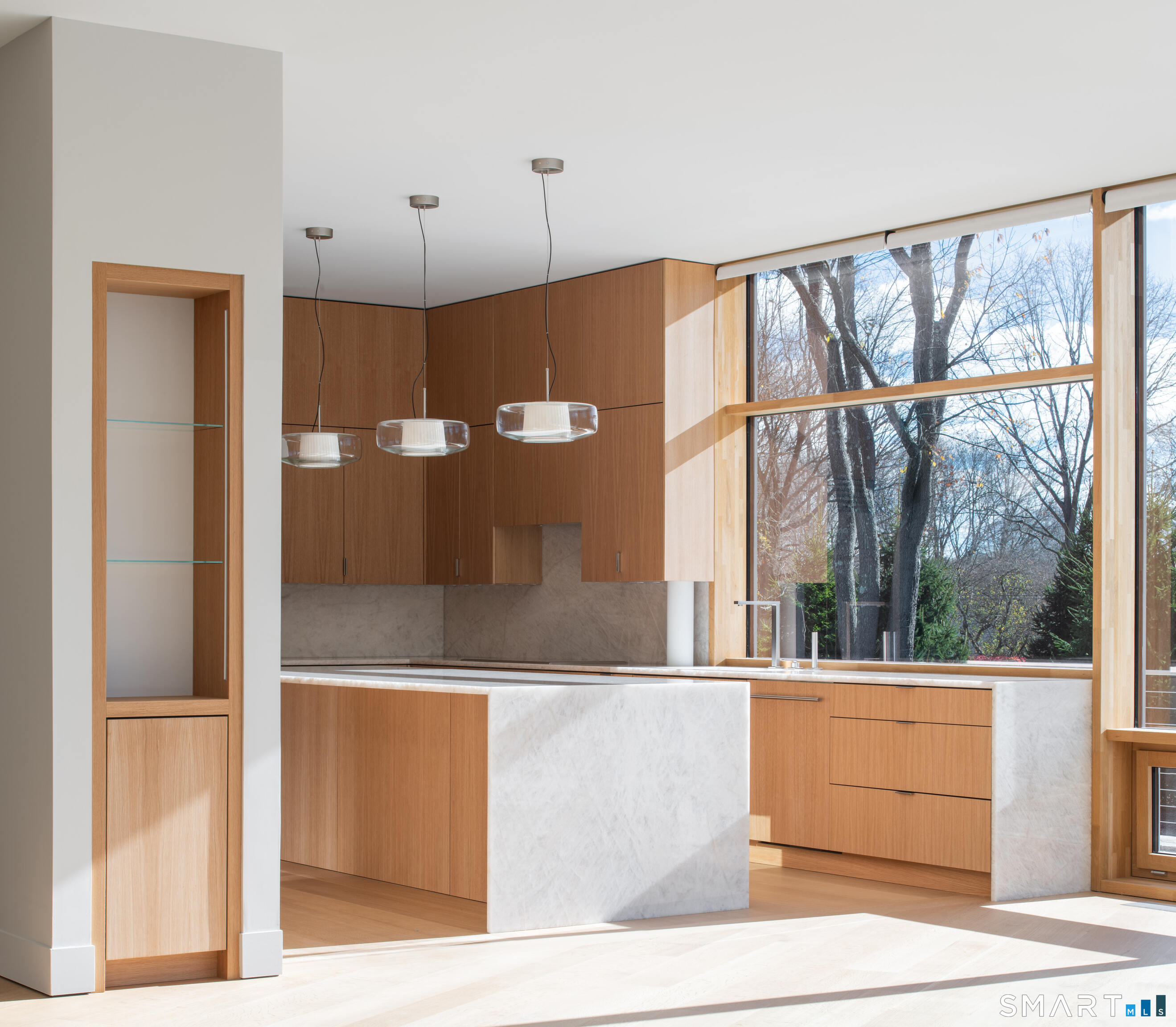 314 Ferry Road Old Lyme, CT 06371 - Photo 12 of 40 The sleek modern kitchen features a huge 10ft X 4ft island and is well appointed with a Wolf induction range, traditional oven and speed oven.