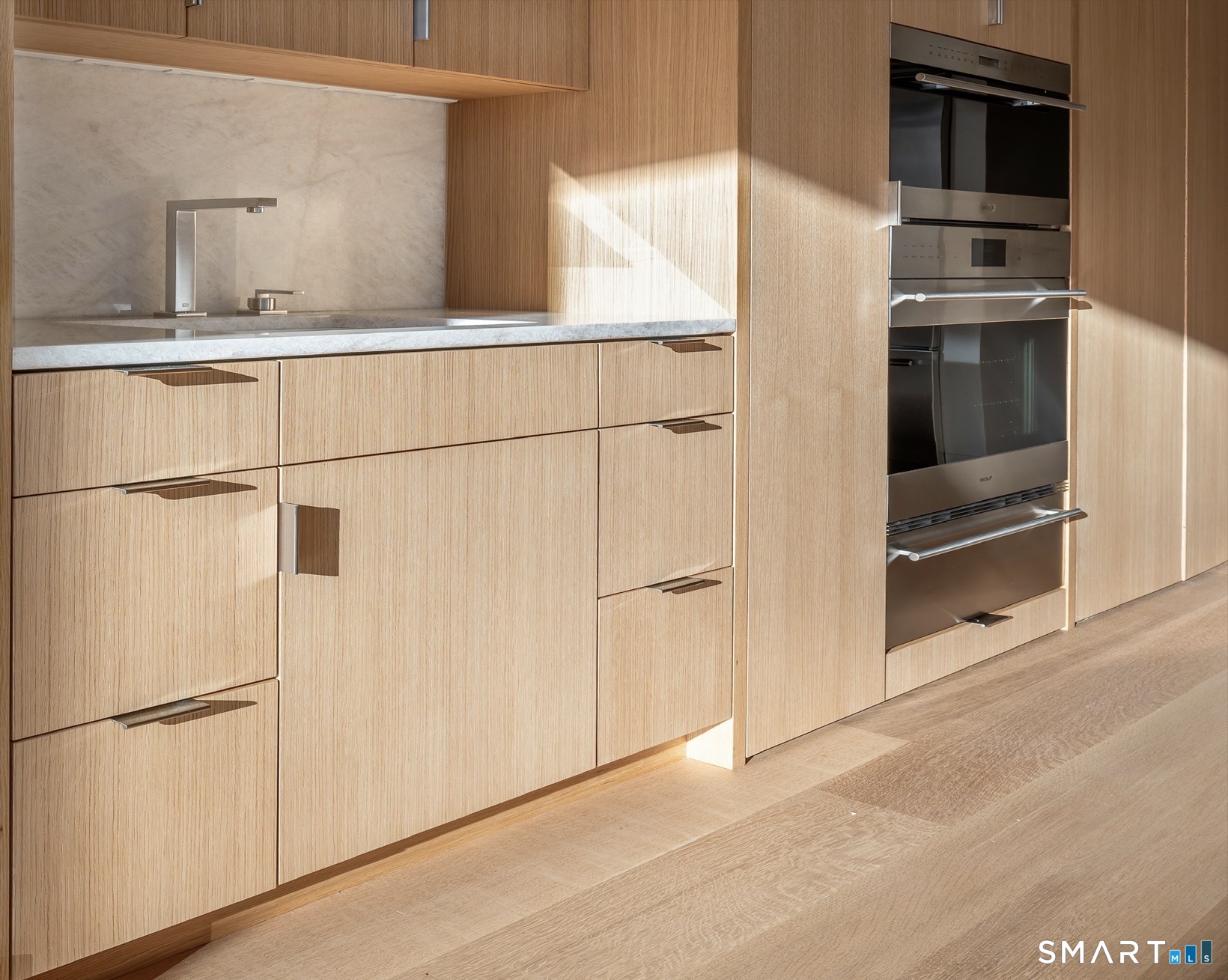 314 Ferry Road Old Lyme, CT 06371 - Photo 15 of 40 Custom cabinetry in the kitchen continues the sleek contemporary look.