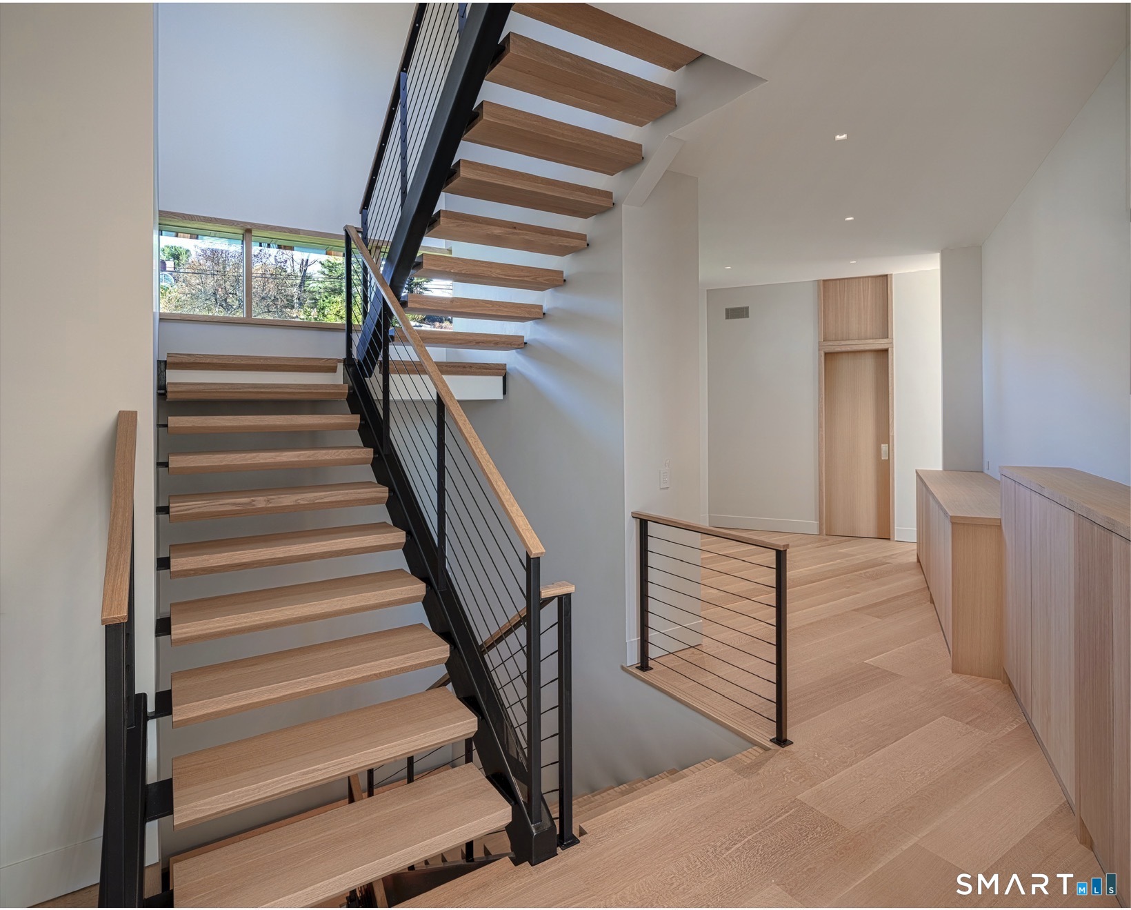 314 Ferry Road Old Lyme, CT 06371 - Photo 26 of 40 The open staircase is a work of art: white oak treads; black cable railings; a windowed landing and a soaring display wall.