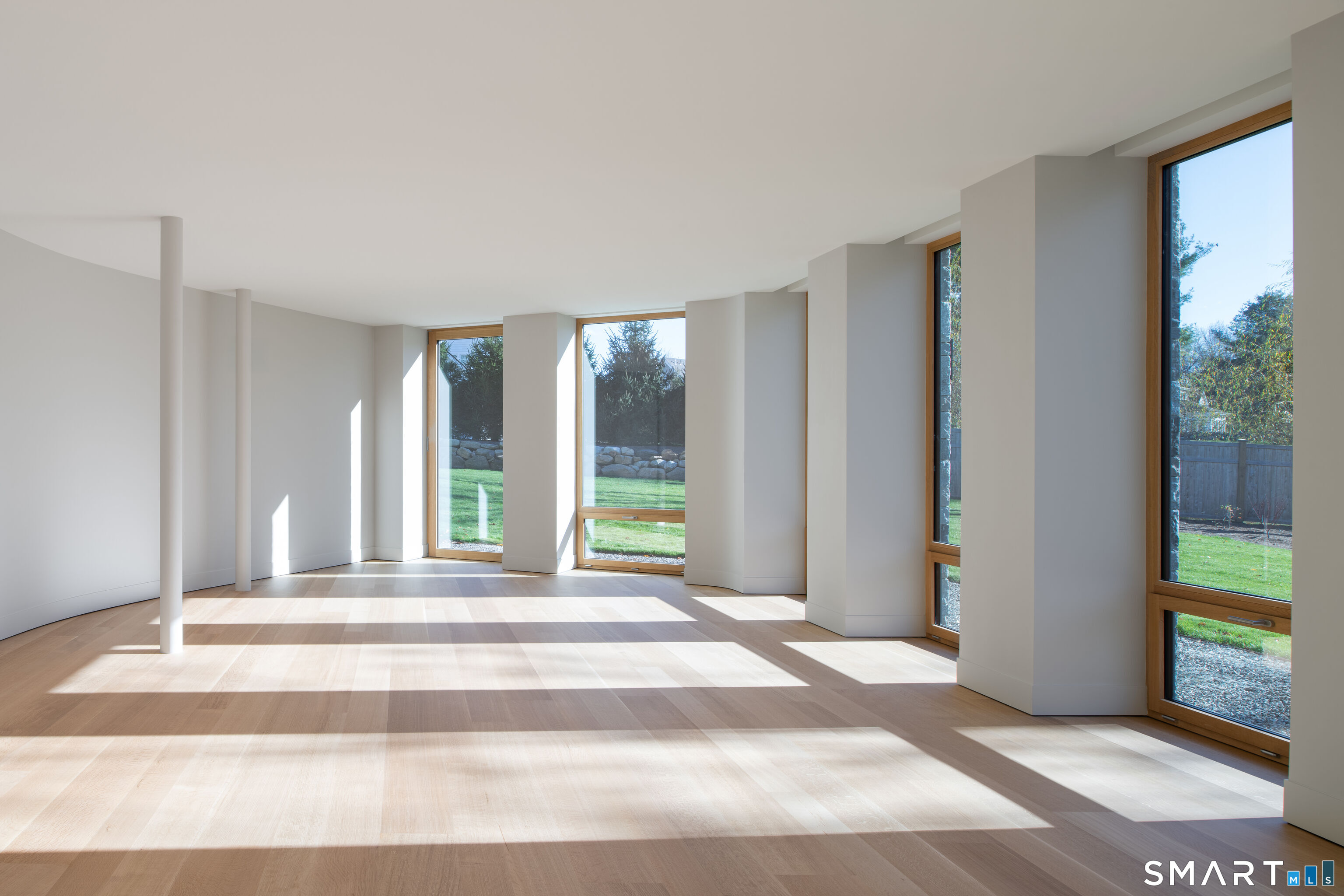 314 Ferry Road Old Lyme, CT 06371 - Photo 27 of 40 At the lower level there is a bonus room including 650 square feet of finished space with south facing floor-to-ceiling windows provides direct access to the beautiful backyard. The space is very versatile and would be ideal as a game room or gym.