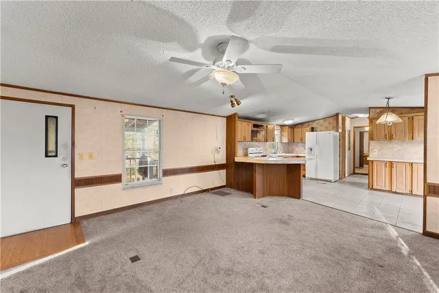 a kitchen with refrigerator and cabinets