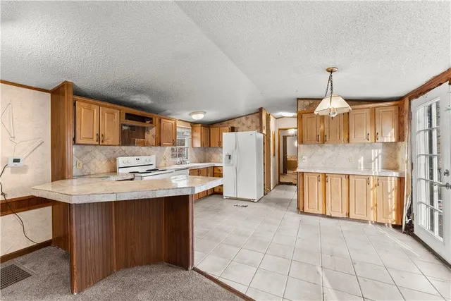 a kitchen with stainless steel appliances granite countertop a sink and cabinets