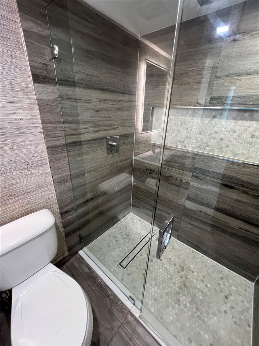 Ives Estates Miami, FL 33179 - Photo 14 of 18 a bathroom with a toilet and a shower