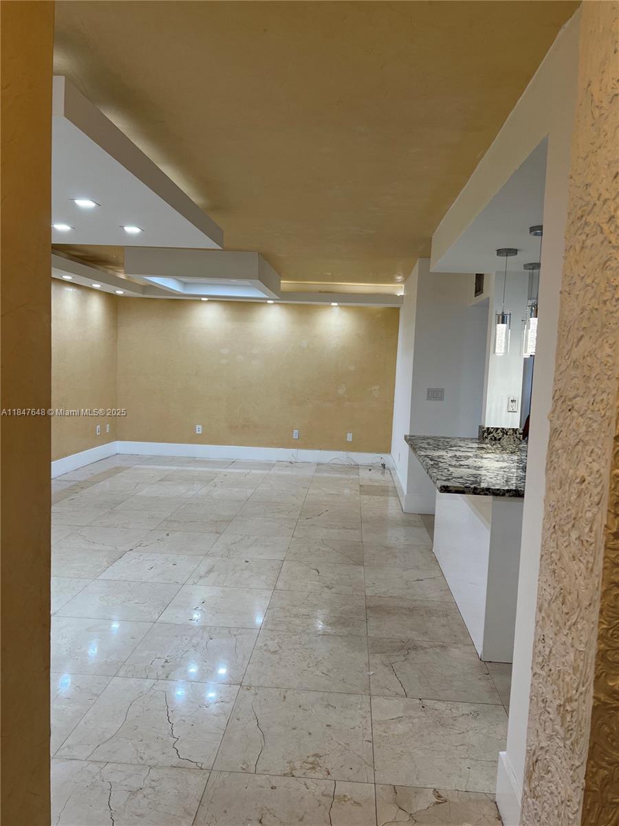 Ives Estates Miami, FL 33179 - Photo 3 of 18 a bathroom with a granite countertop sink a toilet and a mirror