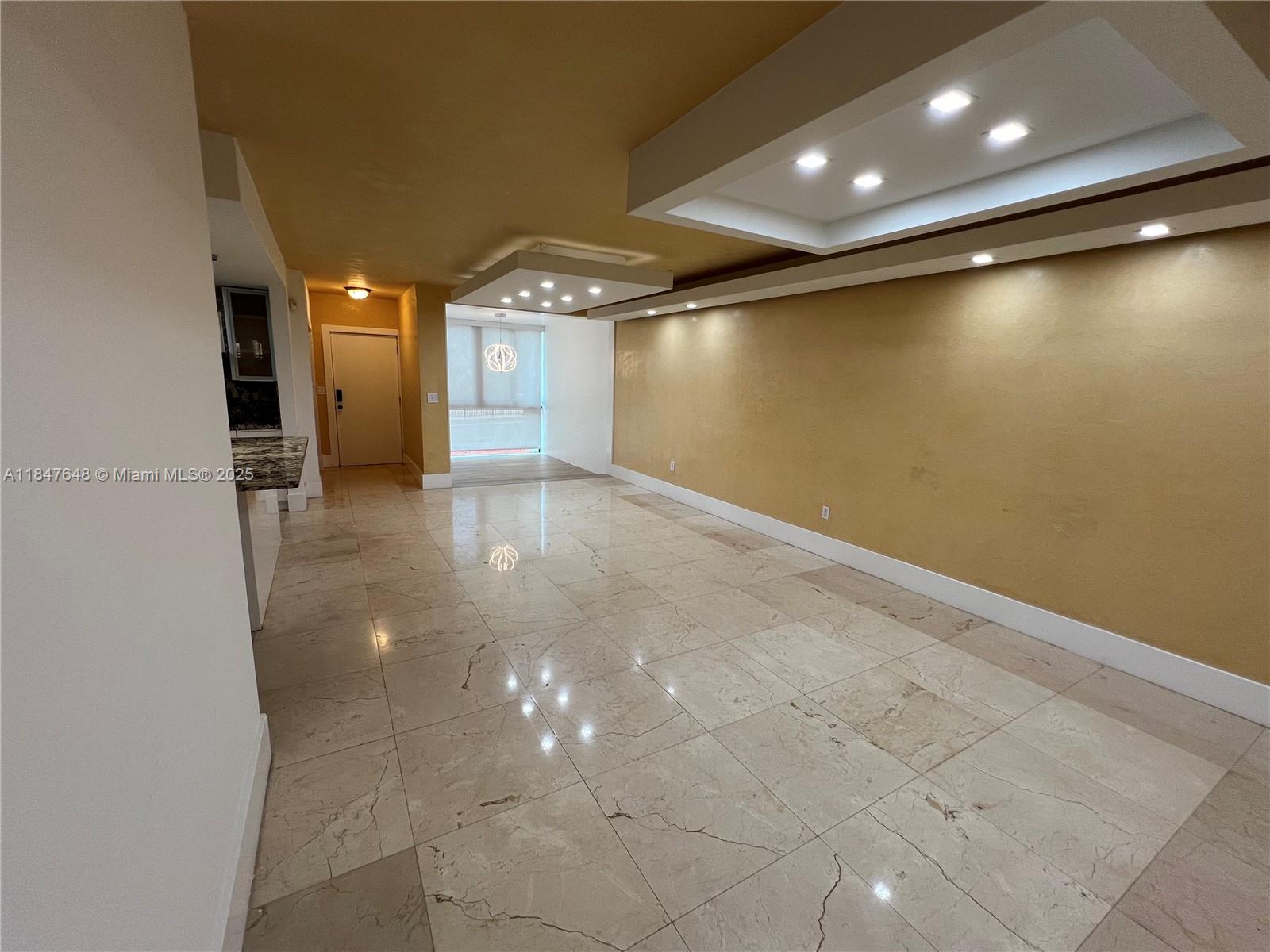 Ives Estates Miami, FL 33179 - Photo 4 of 18 an empty room with wooden floor and windows