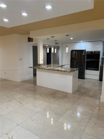a view of a kitchen with a sink and cabinets