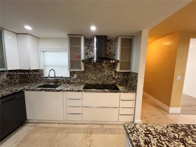 a kitchen with stainless steel appliances granite countertop a sink and cabinets