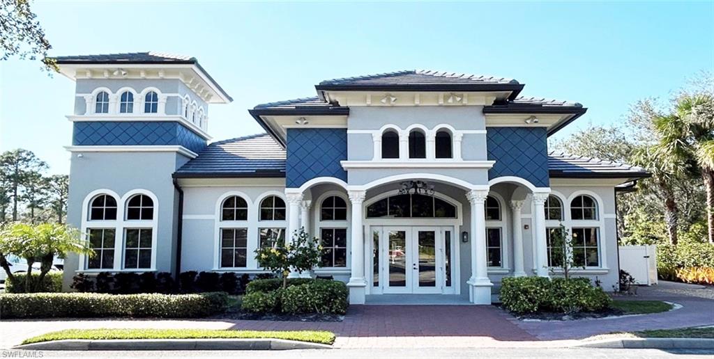 3530 Lansing Loop, Unit 202 Estero, FL 33928 - Photo 30 of 35 a front view of a house with a yard