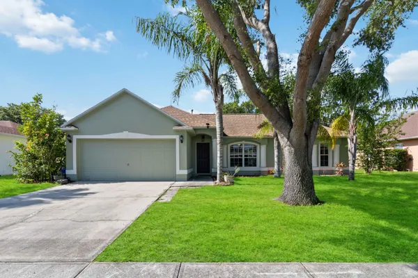 a front view of house with yard and green space