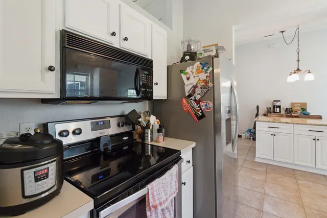 a kitchen with stainless steel appliances granite countertop a stove and a microwave